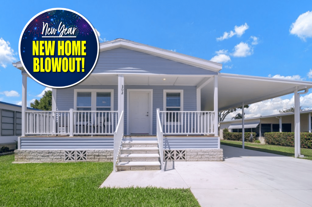 Single-story manufactured home with a covered porch and carport, bright exterior, and a circular "New Year New Home Blowout" promotional graphic in the upper left.